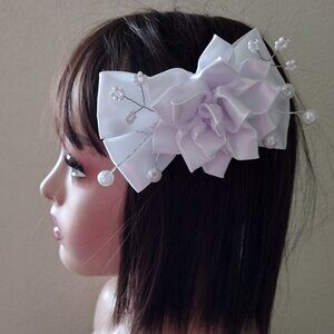 Clip with white satin ribbon flower with pearls for women and girls.